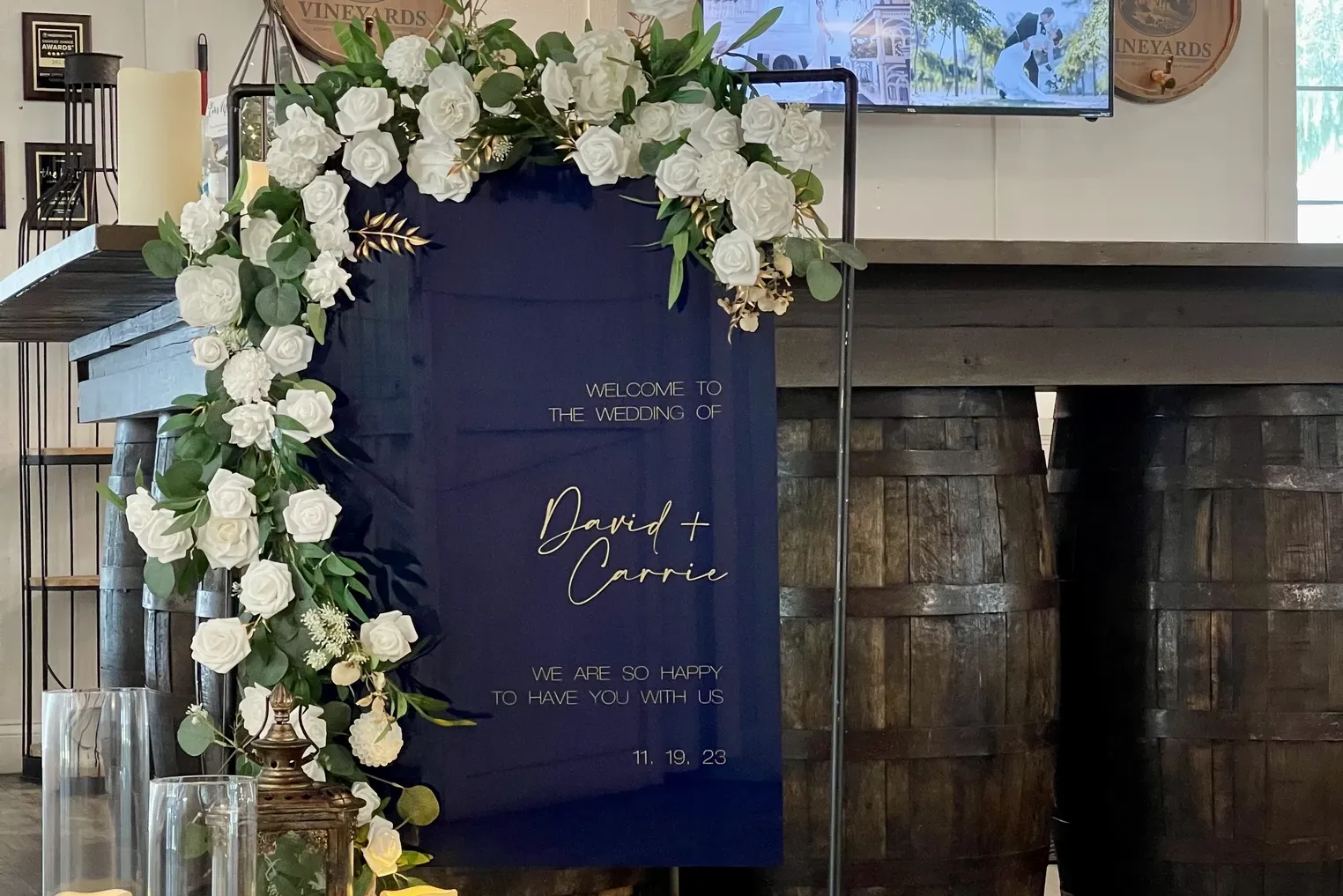 Navy welcome sign with white roses for David and Carrie