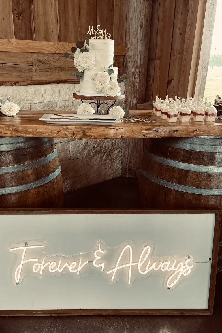 Wedding cake and dessert shooters on a live edge bar