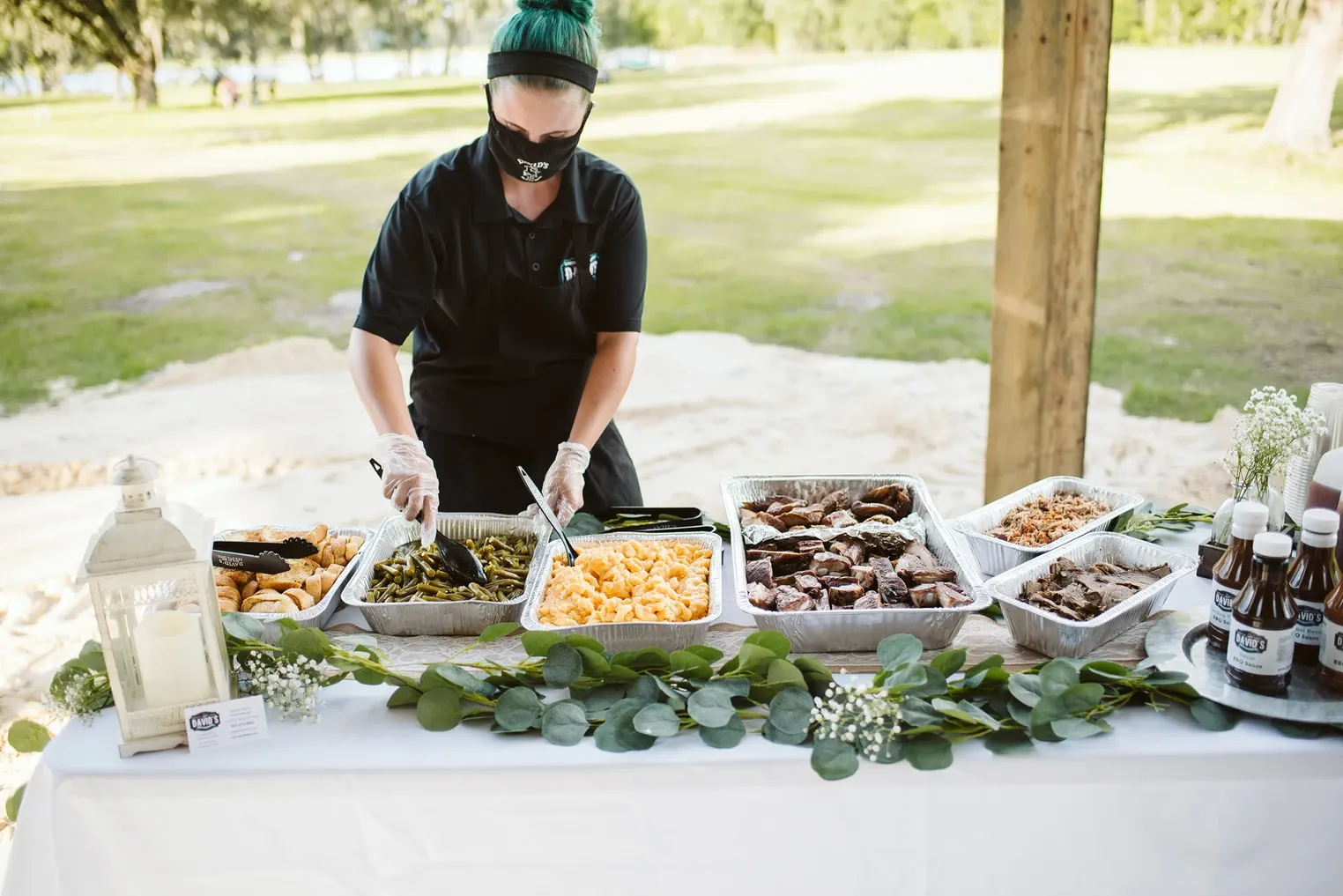 Team member serving a garden buffet with a eucalyptus runner