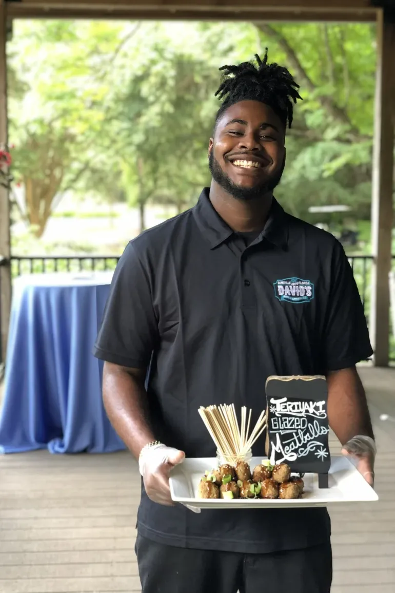 Smiling David's team member in uniform at an outdoor venue