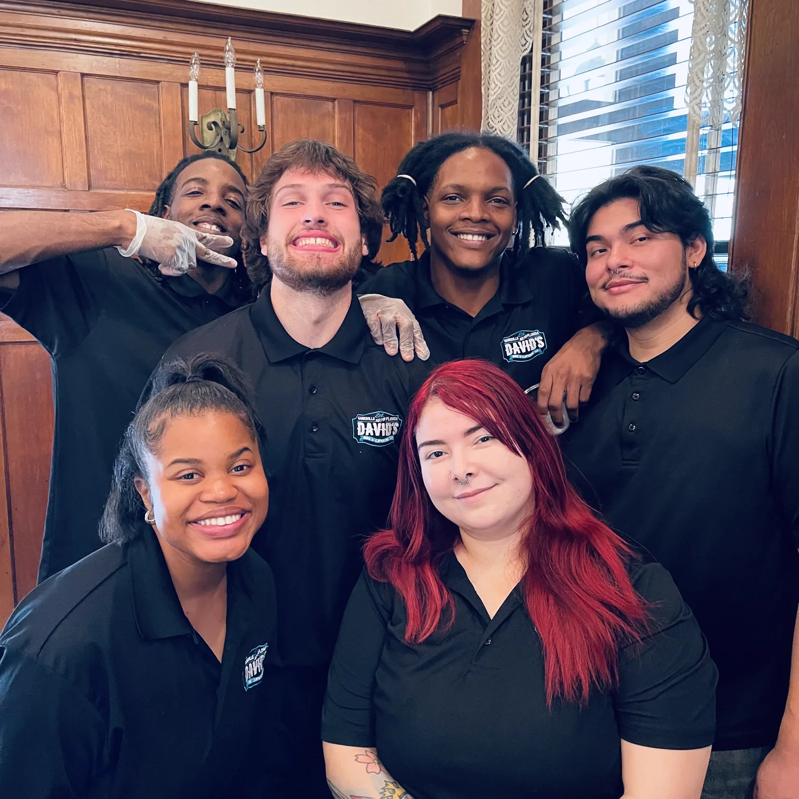 Catering staff grouped together in a wood panelled room