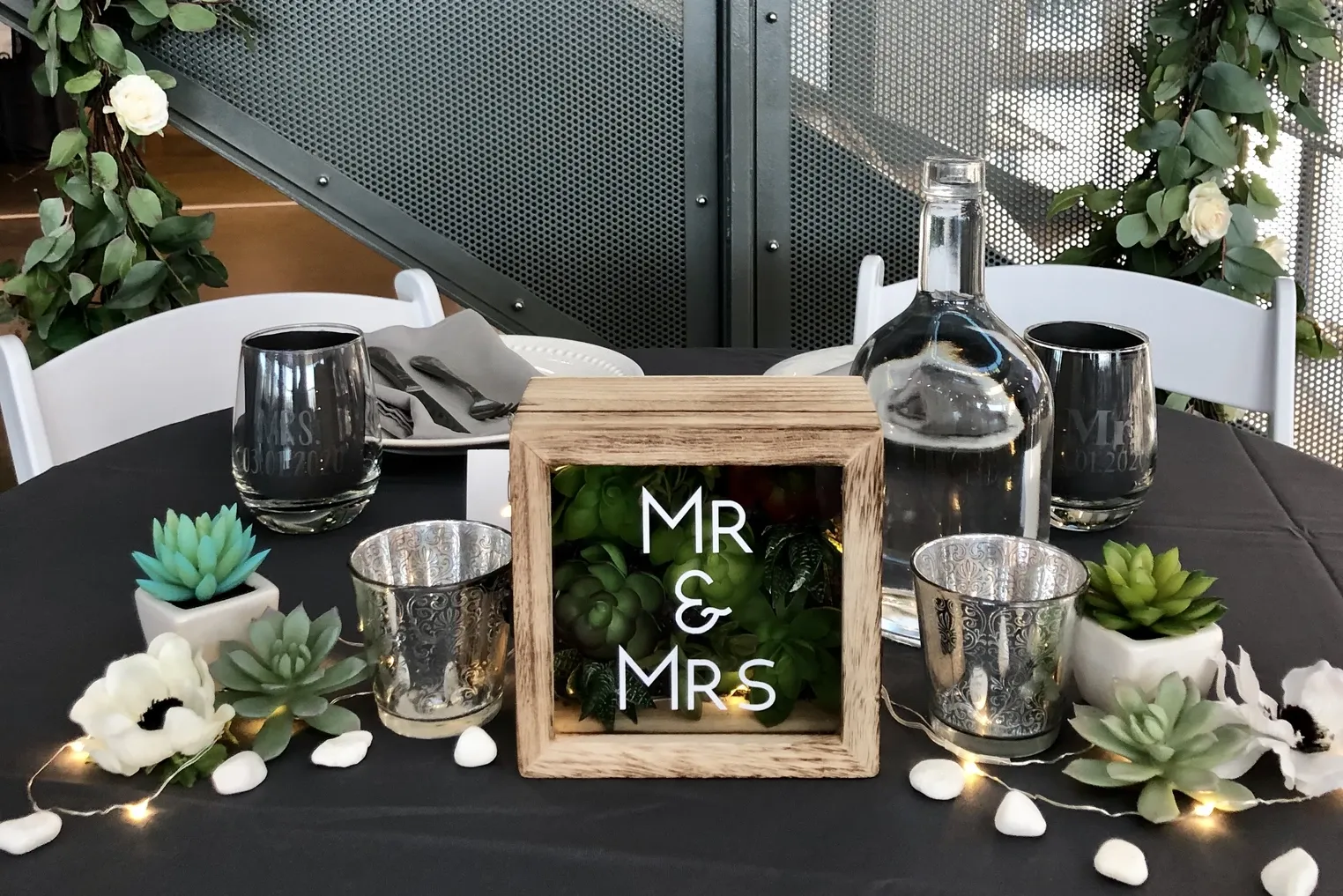 Mr and Mrs marquee box with succulents on a black tablecloth