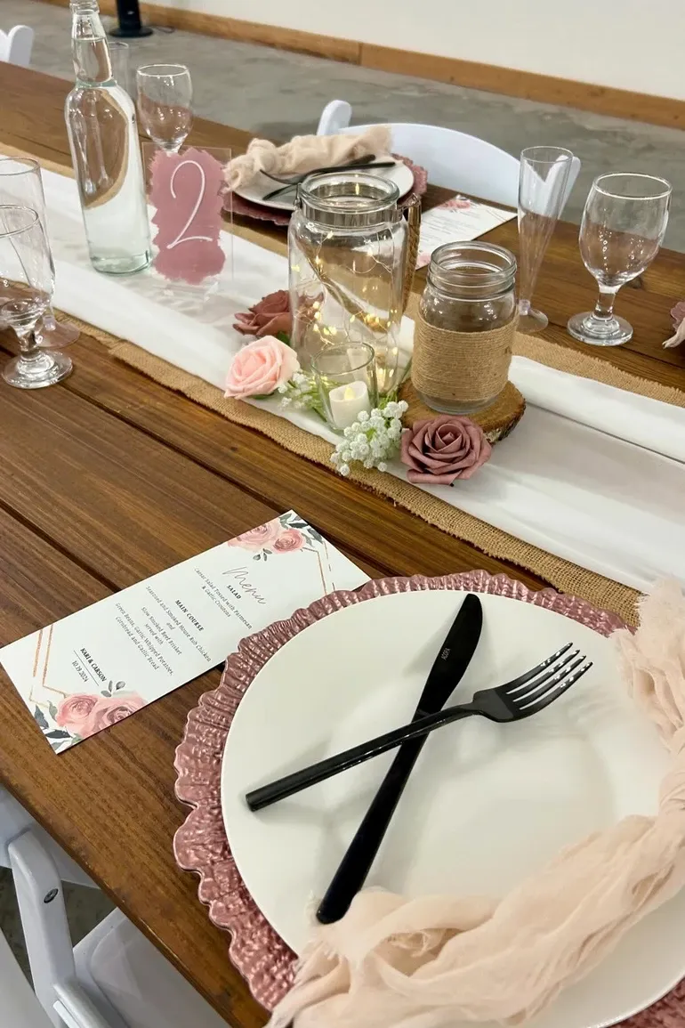 Place setting with a pink lace charger and a printed menu card