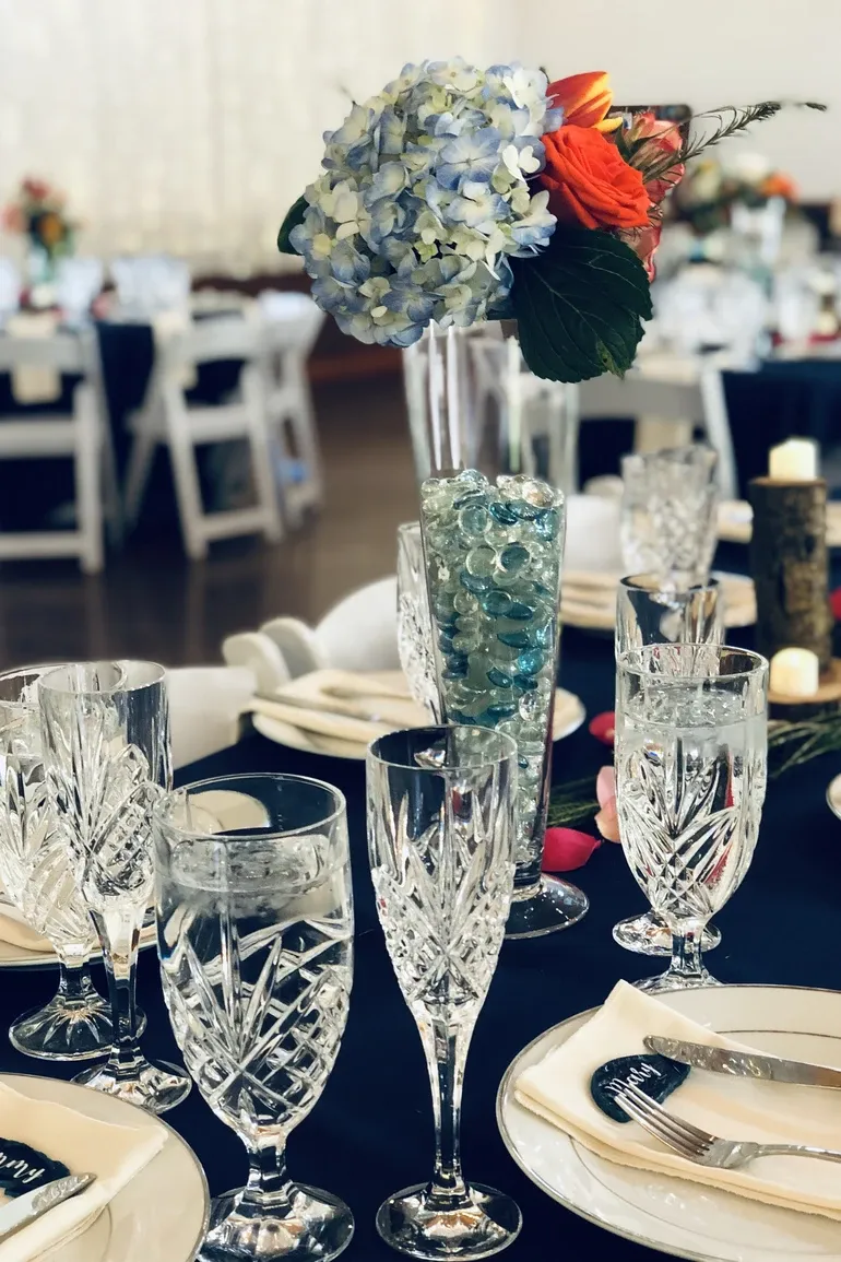 Cut crystal goblets and champagne flutes on a black tablecloth