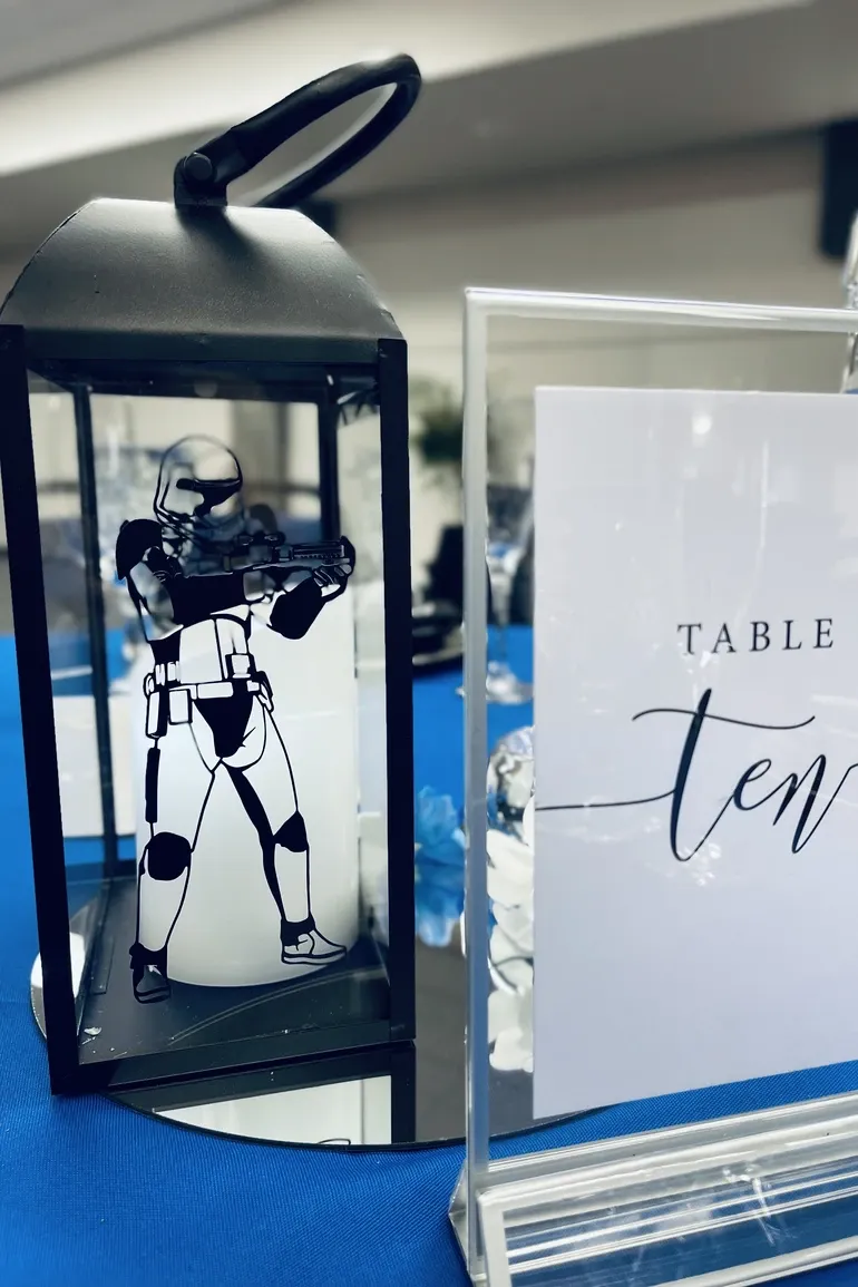 Stormtrooper lantern beside a table ten card