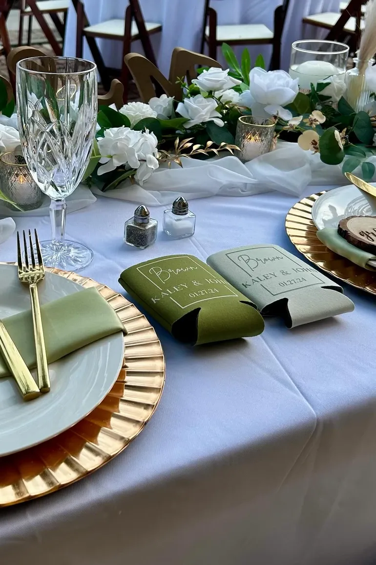 Gold chargers with custom drink koozies for the couple