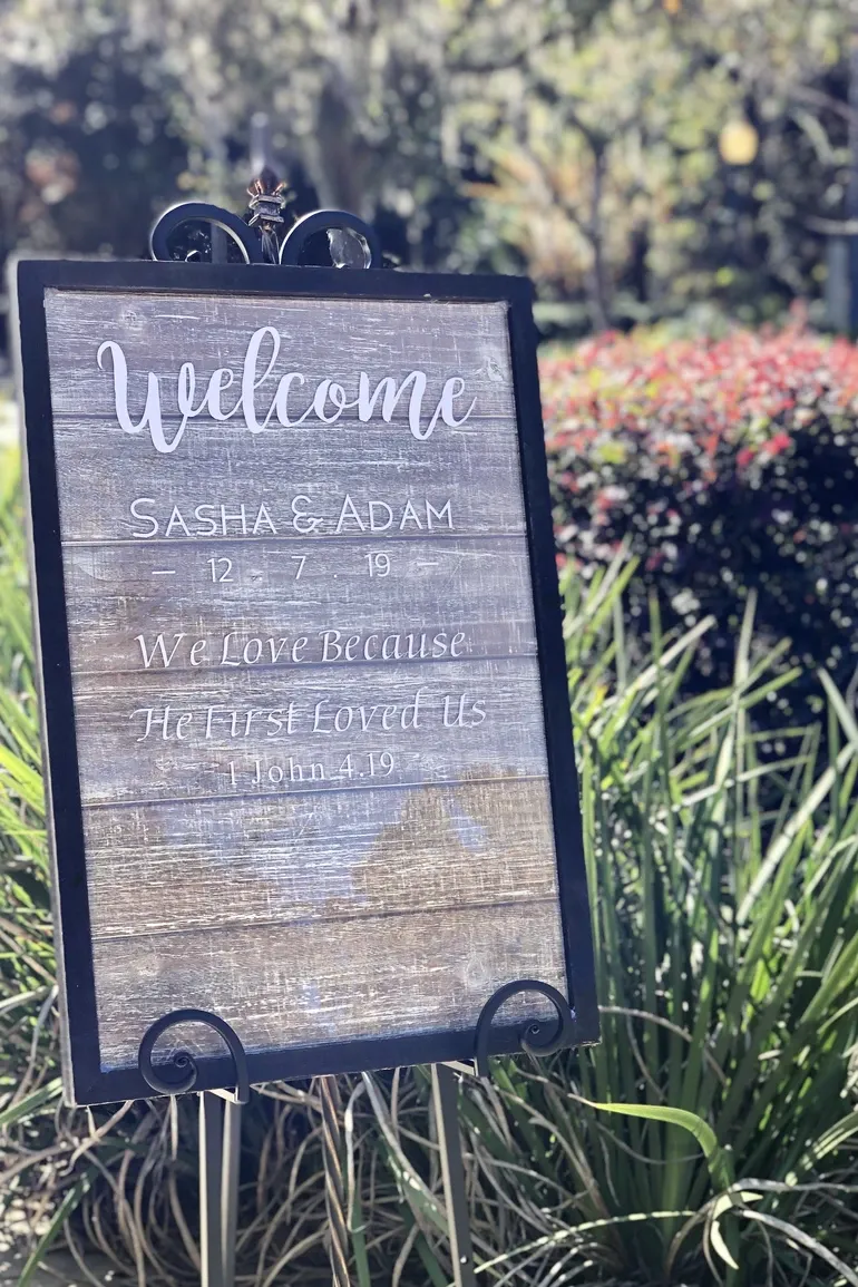 Wooden welcome sign for Sasha and Adam