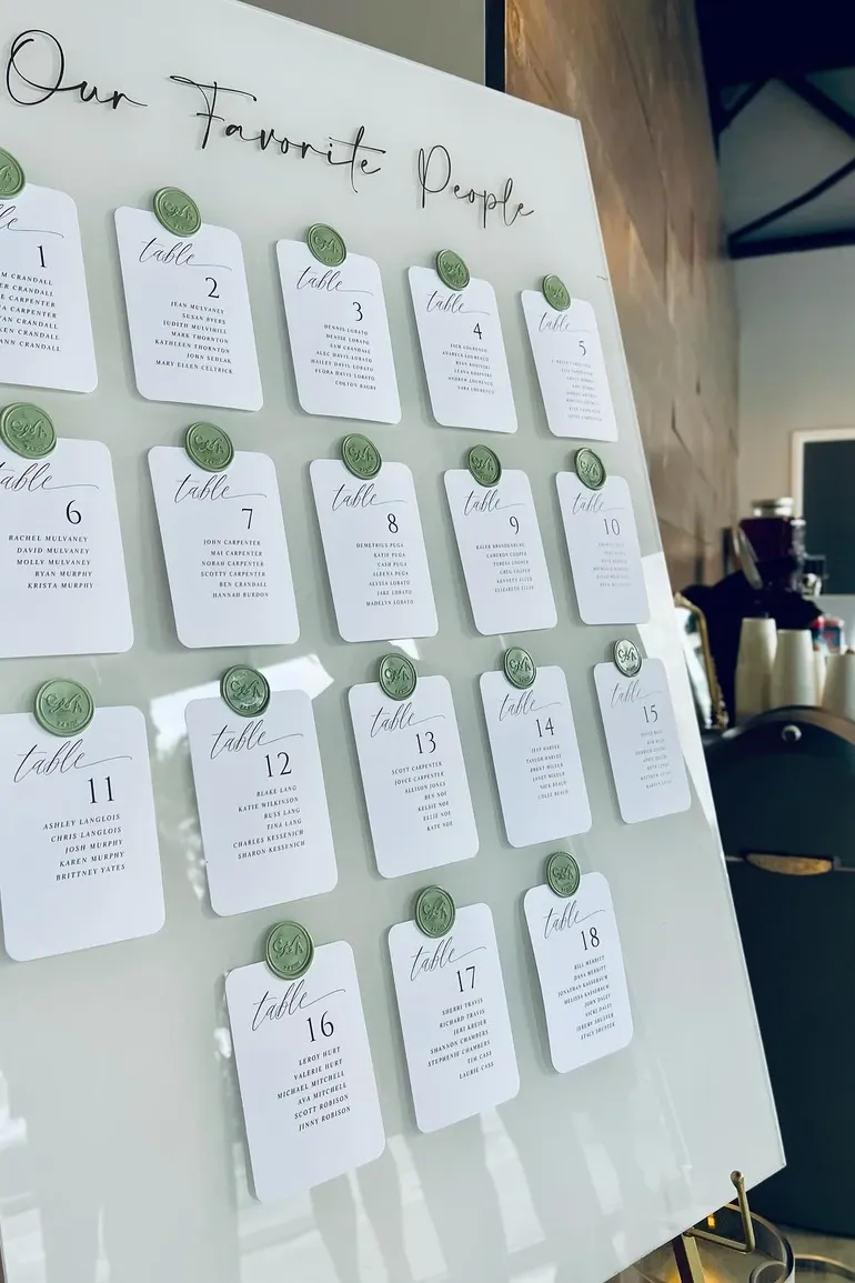 Seating chart cards finished with green wax seals