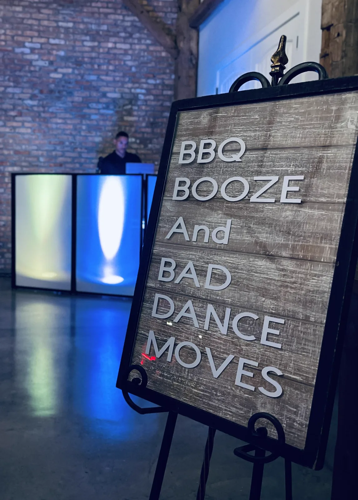 A chalkboard sign reading BBQ, booze and bad dance moves