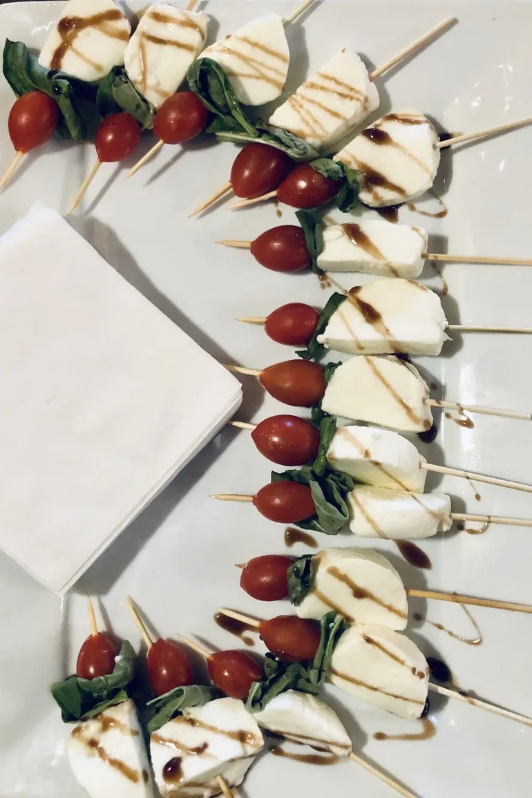 Rows of caprese skewers with balsamic glaze