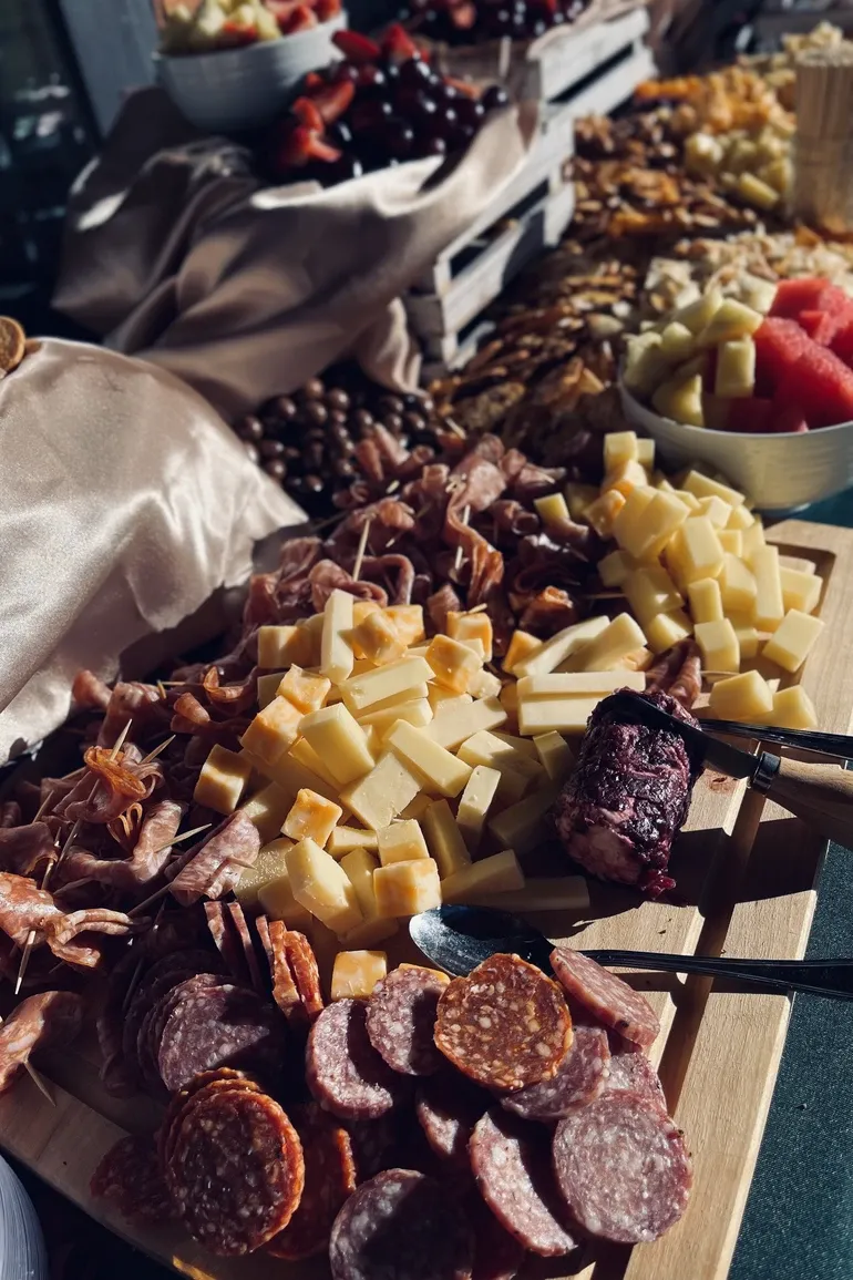 Charcuterie board with salami, cheeses, and berries