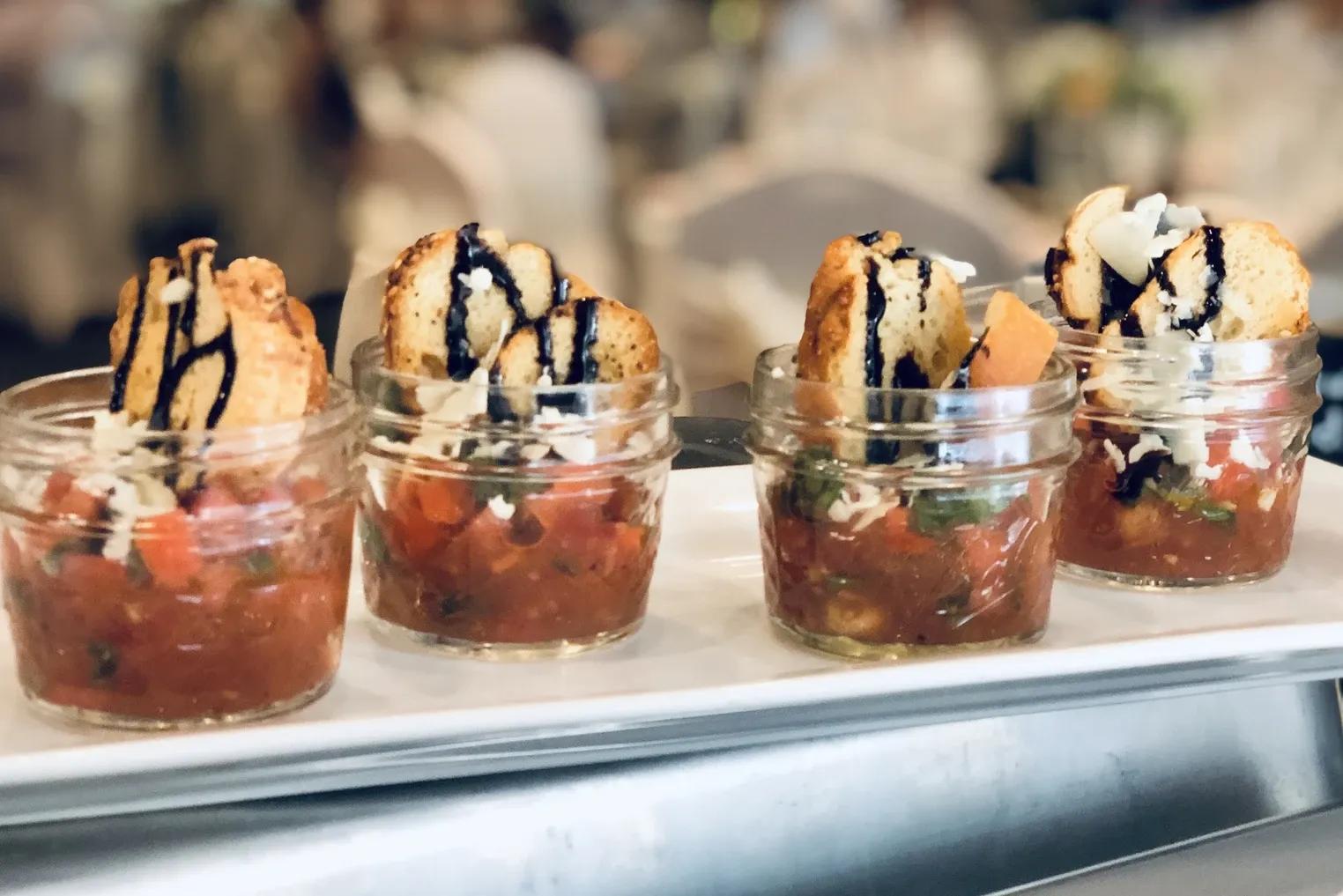 Bruschetta served in mason jars with crostini