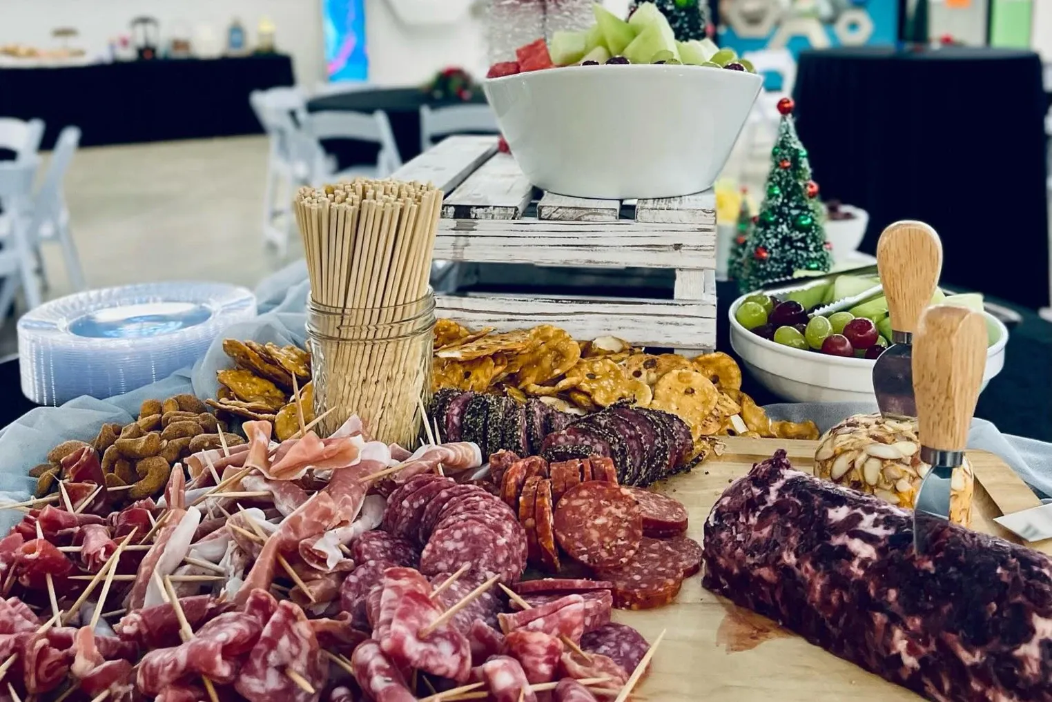 Outdoor charcuterie in crates with breadsticks and fruit