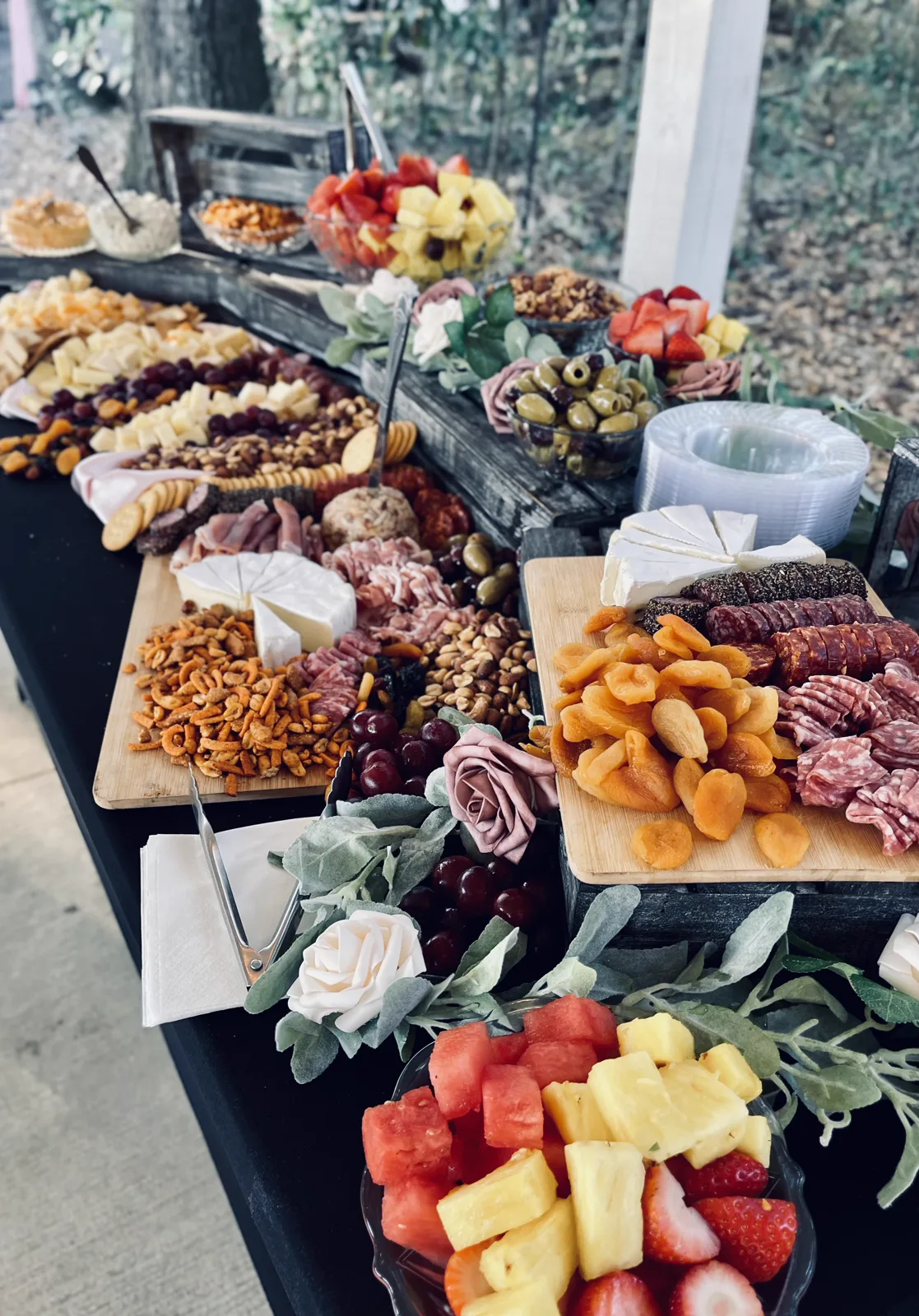 A long grazing table of charcuterie, fruit and cheese