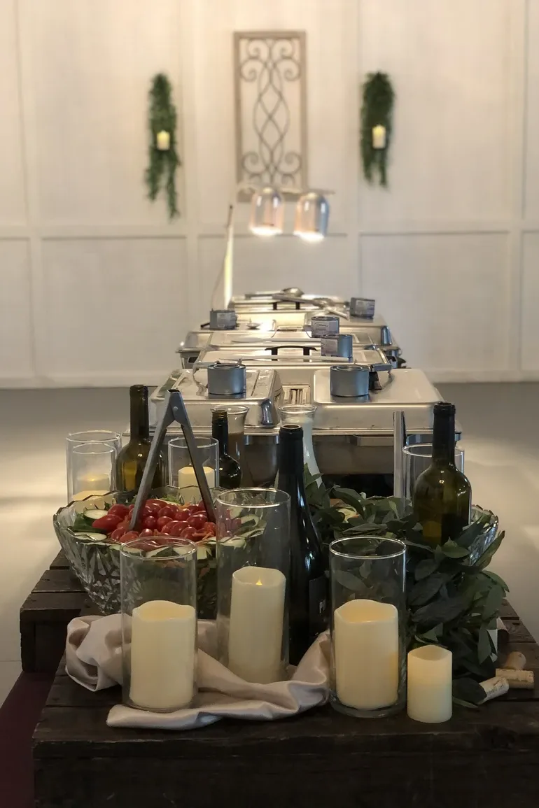 Buffet line of stainless warmers ready in a paneled hall