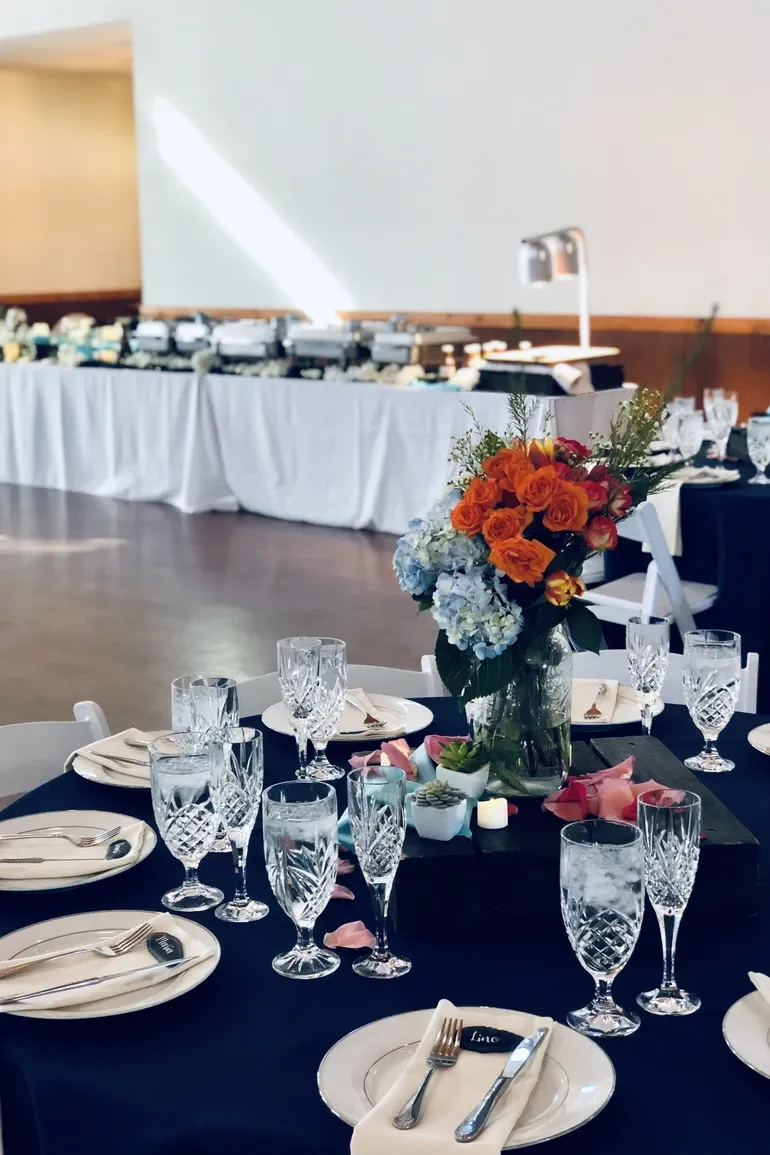 Navy tablescape with orange florals and cut crystal glassware