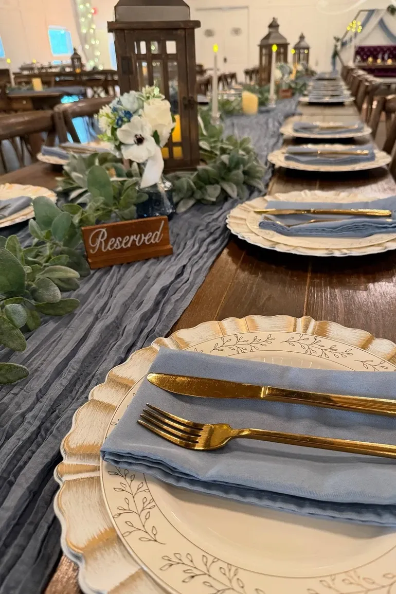 Farm table with a grey runner and a reserved sign