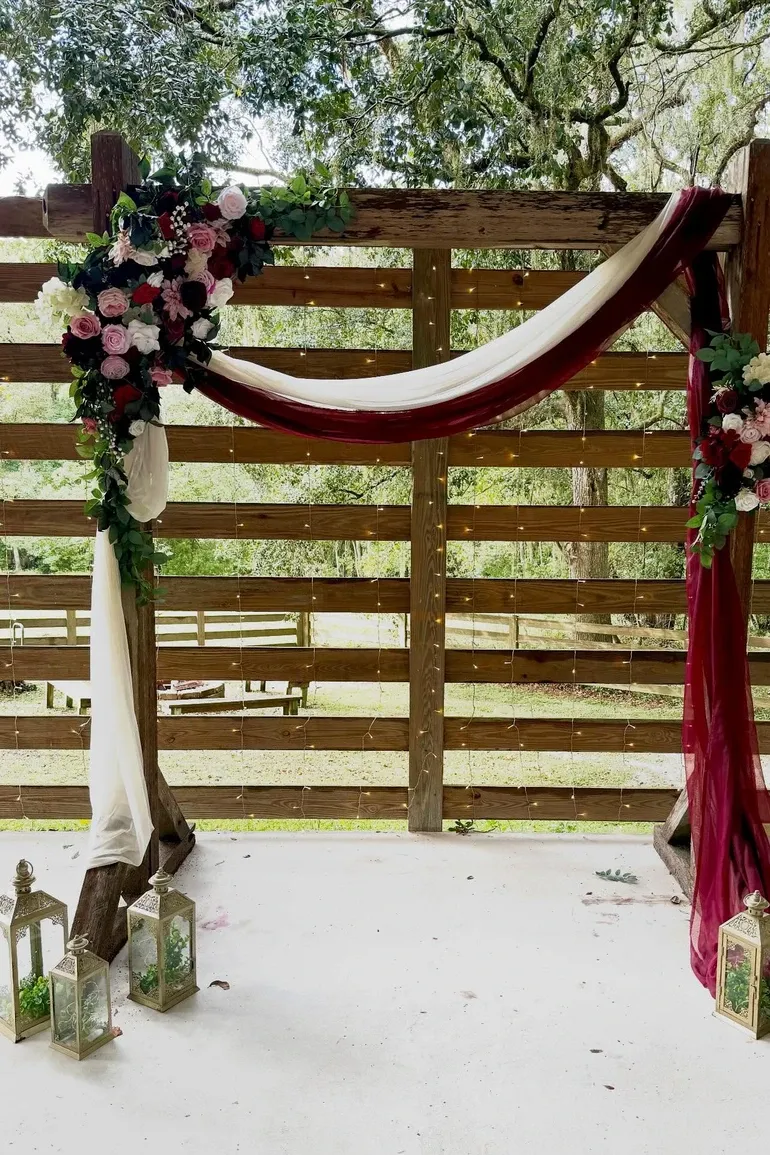 Draped pergola with lanterns ready for a ceremony