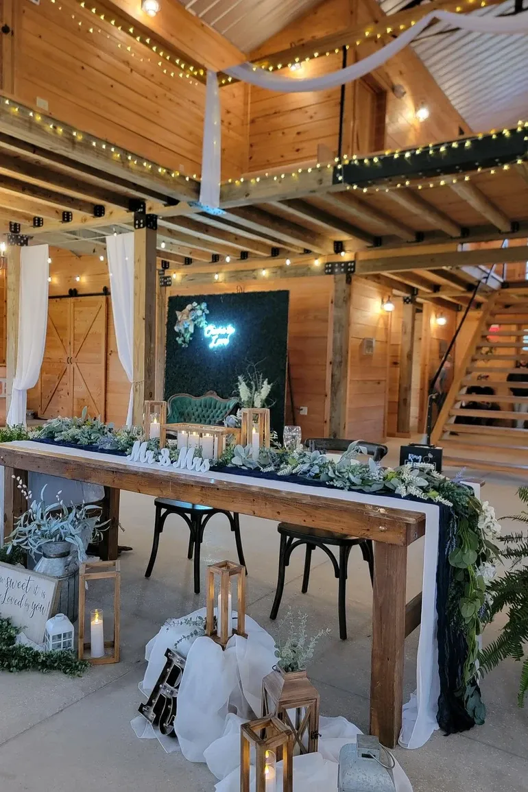 Barn loft with a green velvet sofa above a farm head table