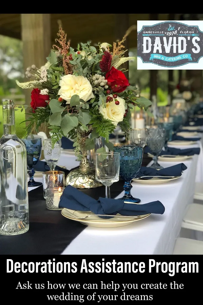 Navy napkins folded on gold rimmed plates with blue goblets