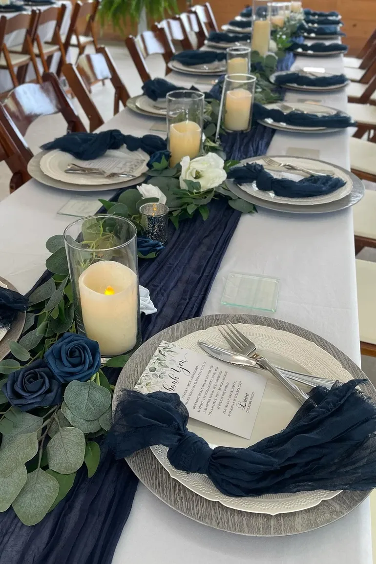 Navy runner with pillar candles and white anemones