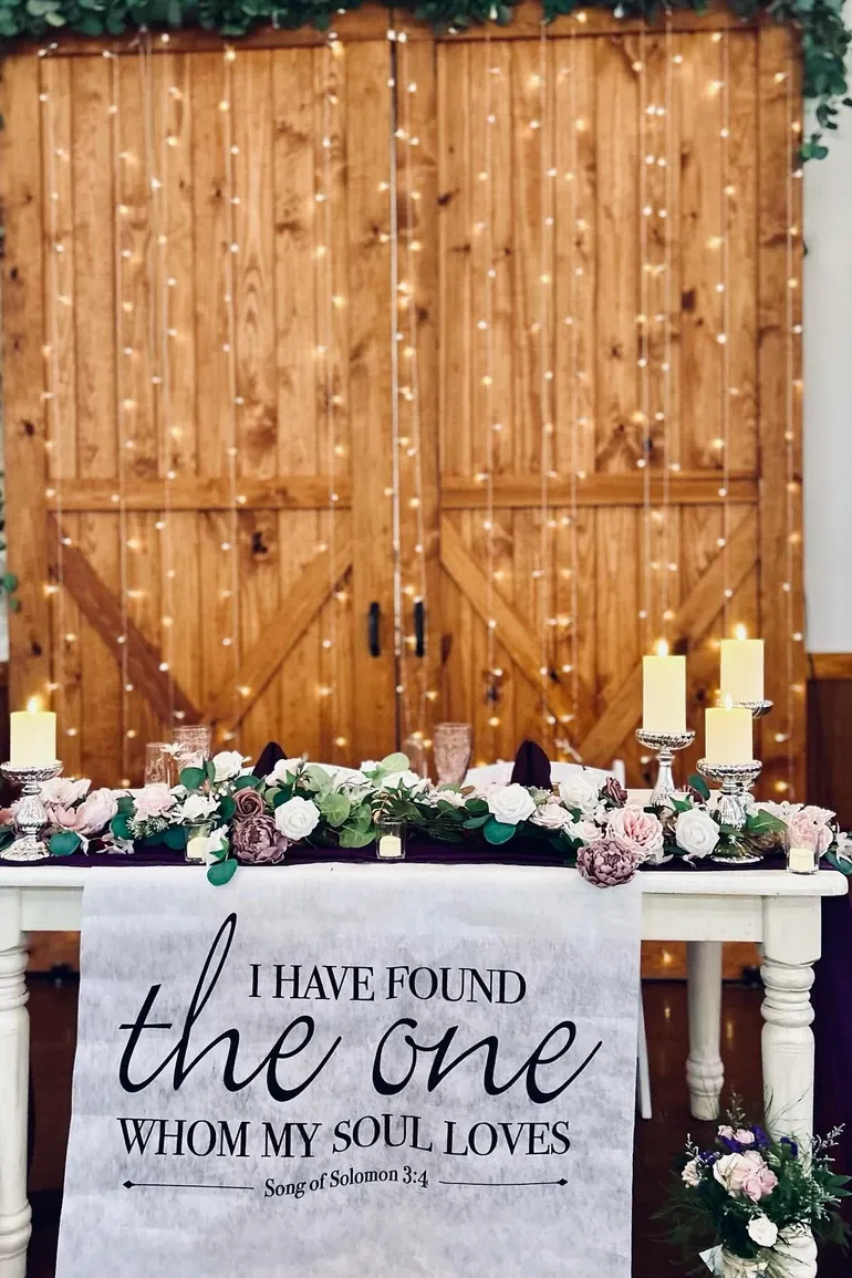 Head table with an I have found the one whom my soul loves banner